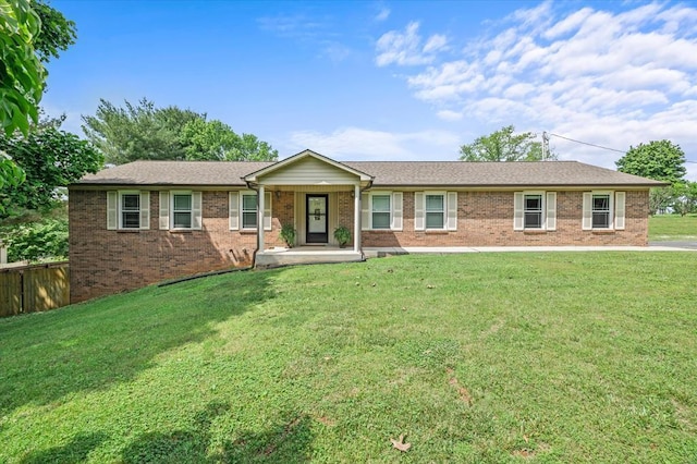 ranch-style home with fence, a front lawn, and brick siding