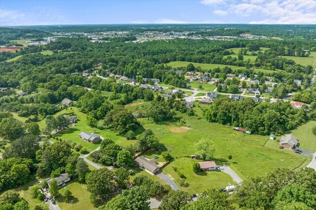 birds eye view of property with a residential view and a wooded view