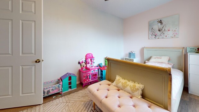 bedroom with wood finished floors