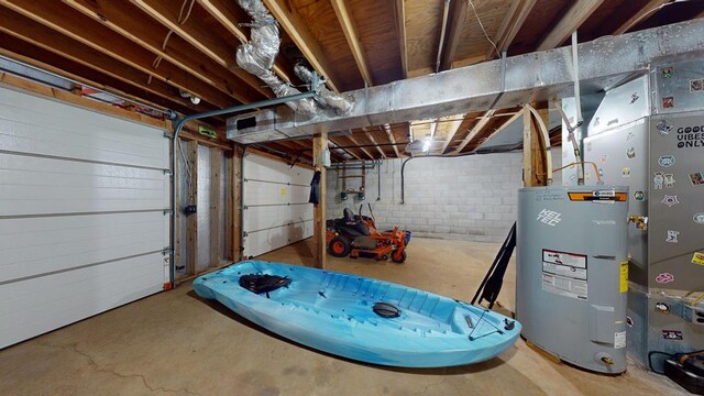 garage featuring concrete block wall and water heater