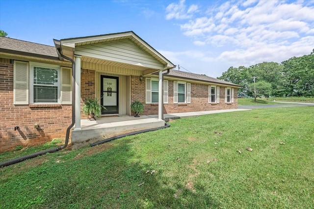 ranch-style house with brick siding and a front lawn