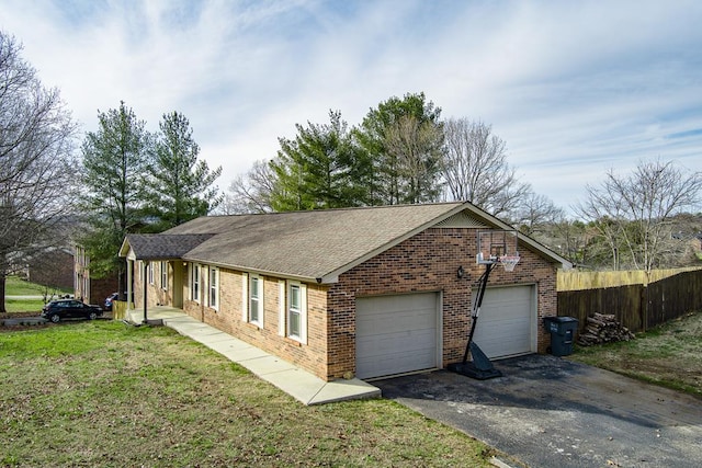 view of property exterior featuring a garage, brick siding, a lawn, and fence