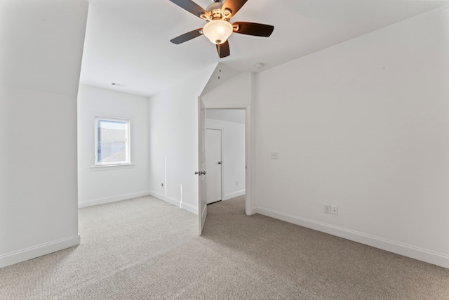 interior space with light carpet, baseboards, and a ceiling fan