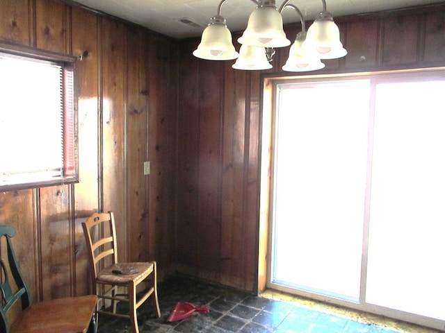 doorway to outside featuring wood walls