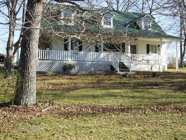 cape cod house featuring a porch and a front yard