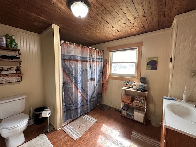 full bathroom featuring vanity, a shower with curtain, wood finished floors, wooden ceiling, and toilet