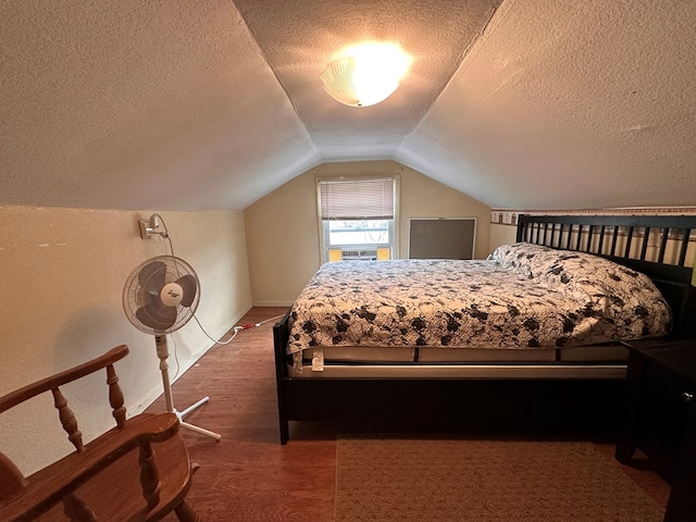 bedroom featuring a textured ceiling, baseboards, and vaulted ceiling