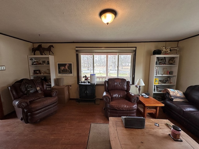 living room featuring a textured ceiling, wood finished floors, and crown molding