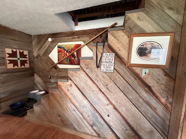 interior details featuring a textured ceiling and wood finished floors