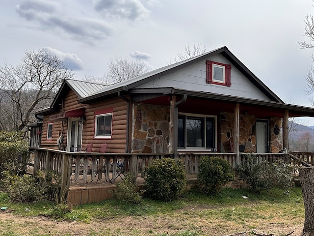 view of front facade featuring stone siding and covered porch