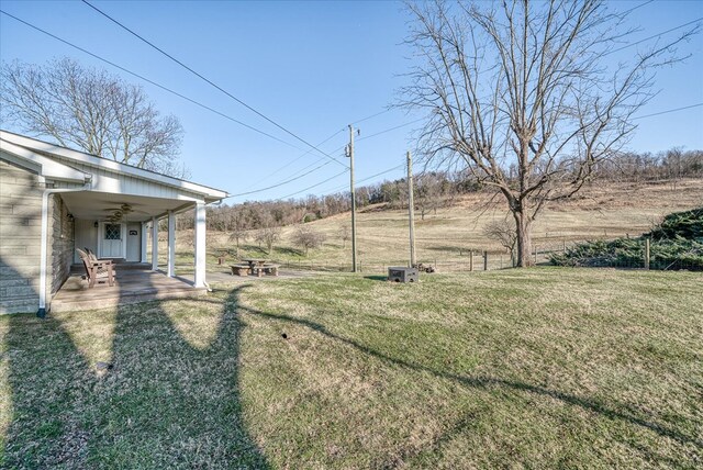 view of yard with a rural view and a patio