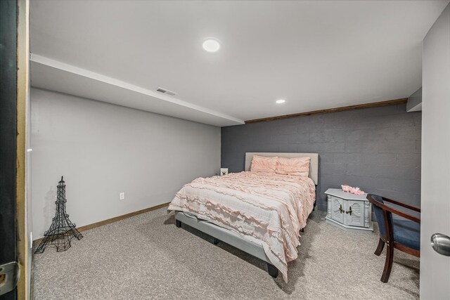 carpeted bedroom with recessed lighting, visible vents, concrete block wall, and baseboards