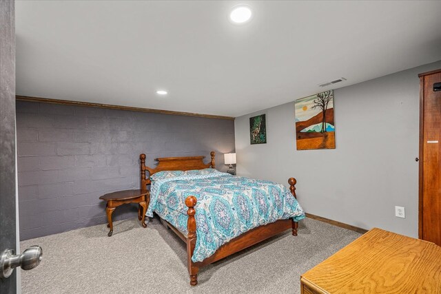 bedroom with recessed lighting, carpet flooring, visible vents, baseboards, and concrete block wall