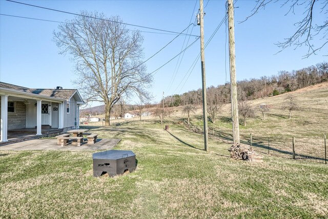 view of yard with fence and a patio