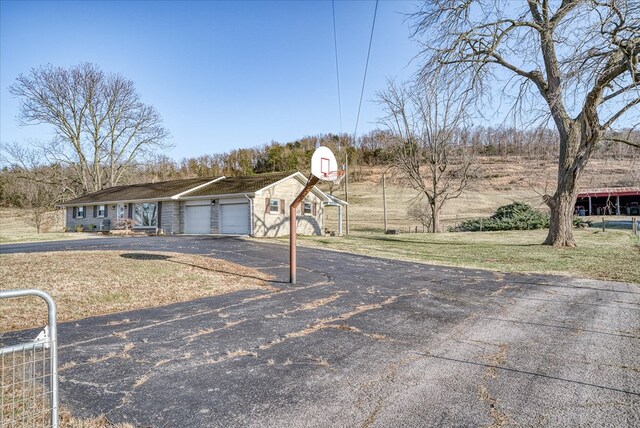 view of yard with driveway and an attached garage