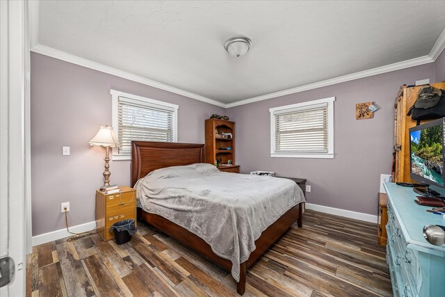 bedroom with ornamental molding, dark wood-style flooring, and multiple windows