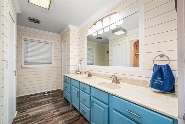 bathroom with double vanity, ornamental molding, and a sink