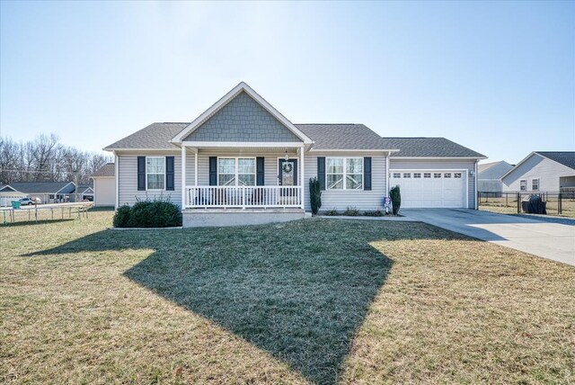 view of front of property with a porch, concrete driveway, fence, a garage, and a front lawn