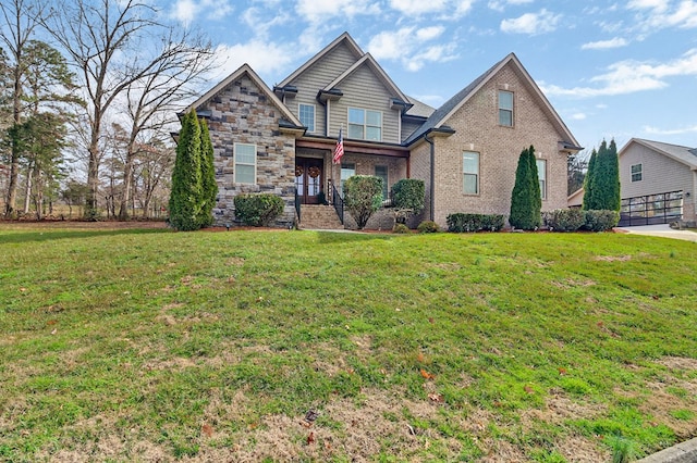 view of front of home featuring brick siding, stone siding, and a front yard