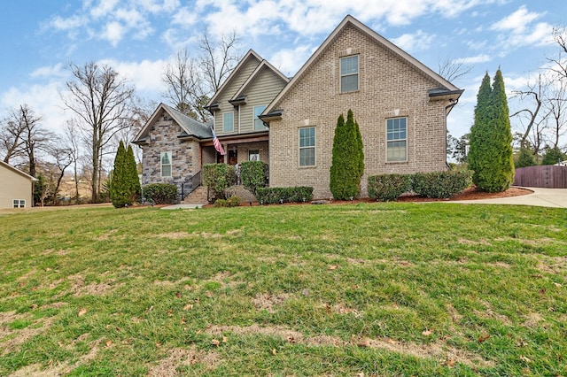 view of front of home featuring a front lawn and brick siding