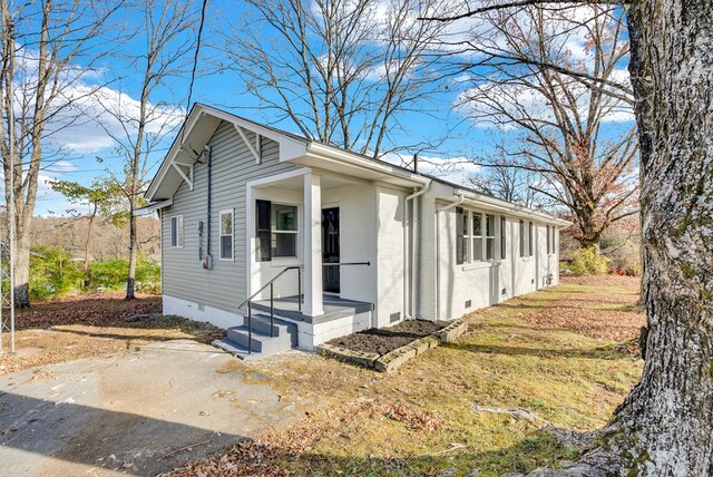 view of property exterior with brick siding and crawl space