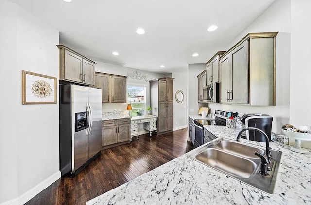 kitchen featuring light stone counters, stainless steel appliances, recessed lighting, dark wood-type flooring, and a sink