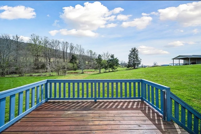 wooden terrace featuring a lawn