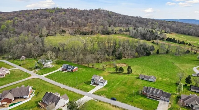 birds eye view of property with a view of trees