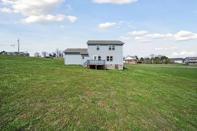 rear view of property with stairway, a deck, and a yard