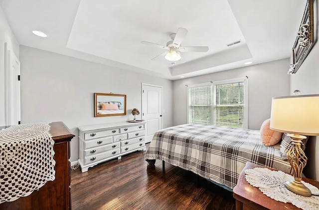 bedroom featuring visible vents, a raised ceiling, ceiling fan, dark wood-type flooring, and recessed lighting