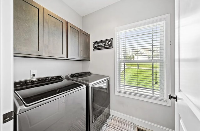 laundry room featuring visible vents, washer and clothes dryer, cabinet space, and baseboards