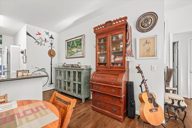 dining space with dark wood-style floors and baseboards