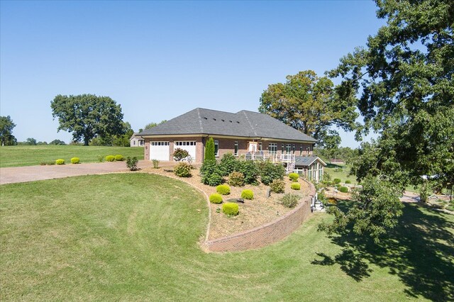 view of front of house with driveway and a front lawn