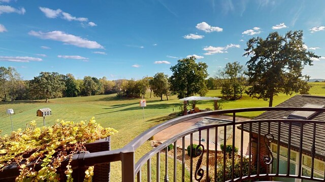 view of home's community featuring a lawn and golf course view