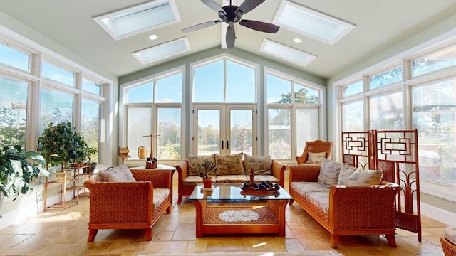 sunroom featuring lofted ceiling with skylight, ceiling fan, and french doors