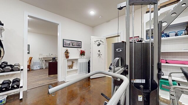 workout area with wood finished floors