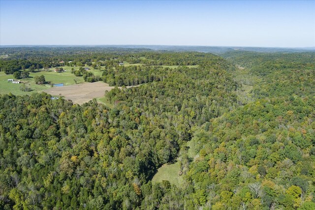 birds eye view of property with a view of trees