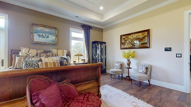 office space featuring a raised ceiling, ornamental molding, wood finished floors, and baseboards