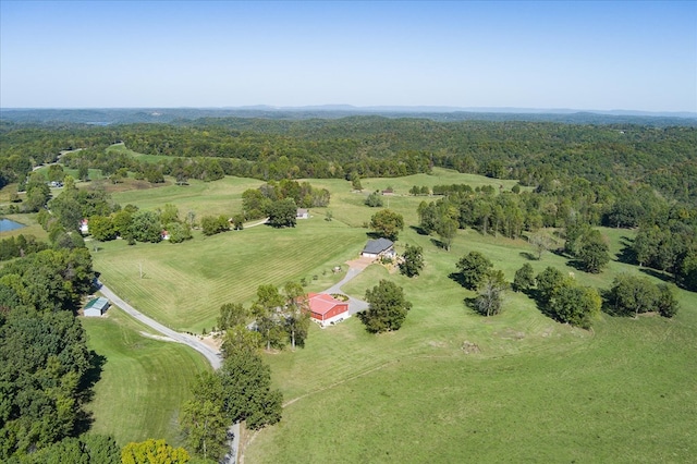 birds eye view of property featuring a rural view and a wooded view