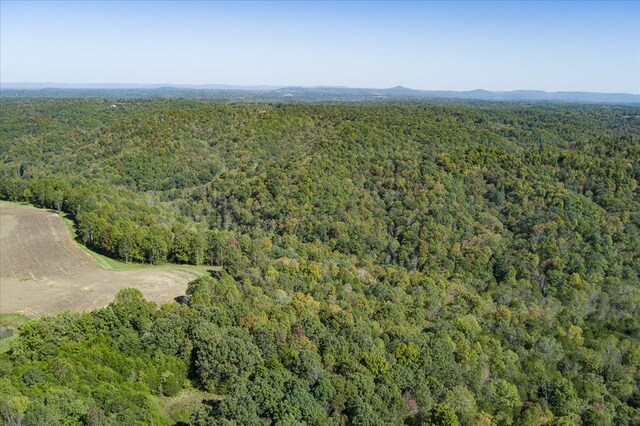 drone / aerial view with a wooded view