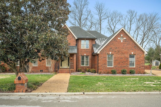 traditional home with brick siding, roof with shingles, and a front yard