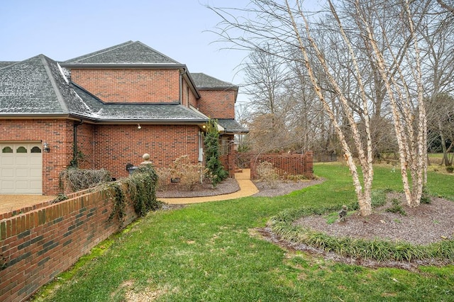 view of yard featuring fence and an attached garage