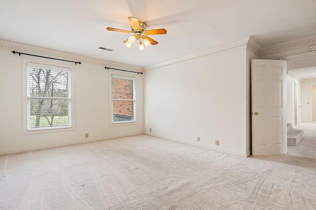 unfurnished room with light carpet, visible vents, and crown molding