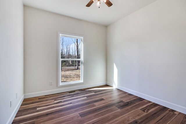 unfurnished room with a ceiling fan, baseboards, and wood finished floors