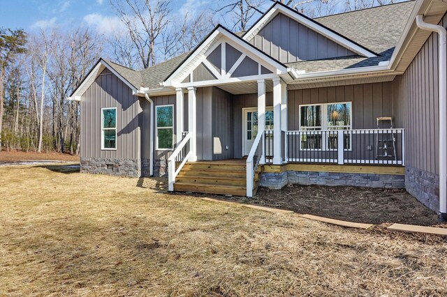 view of front of property featuring a shingled roof, crawl space, a porch, and board and batten siding