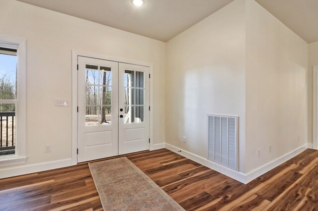 foyer with baseboards, visible vents, dark wood-type flooring, and french doors