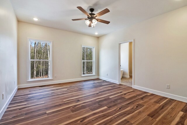 unfurnished room featuring ceiling fan, dark wood-type flooring, recessed lighting, and baseboards