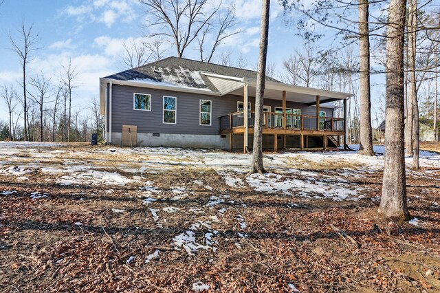 exterior space with roof with shingles, crawl space, and a wooden deck