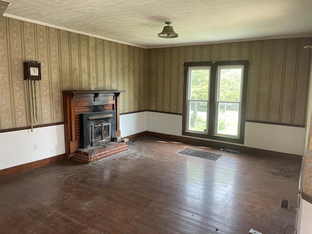 unfurnished living room featuring ornamental molding, baseboards, and wallpapered walls