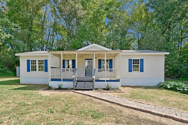 manufactured / mobile home featuring a porch and a front yard